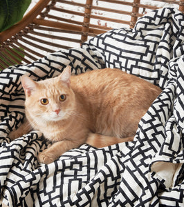 cat laying on naya black and white geometric pet quilt