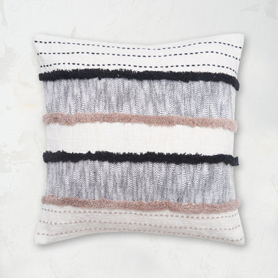 Benn Onyx Pillow styled with woven horizontal patterns and tufted textures.
