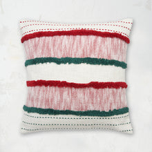 Benn Ruby Pillow styled with woven horizontal patterns and tufted textures.