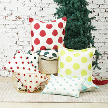Ruby Dot Oblong Pillow, Surf Dot Oblong Pillow, and Jungle Dot Oblong Pillow with pom pom embellishments in classic polka dot style with matching border.  Dot Pillows in Citron, Jungle, Ruby, and Surf on cotton slub with a blanket stitch finish. 