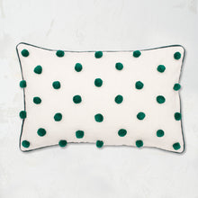 Jungle Dot Oblong Pillow with pom pom embellishments in classic polka dot style with matching border.