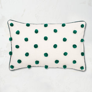 Jungle Dot Oblong Pillow with pom pom embellishments in classic polka dot style with matching border.