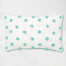 Surf Dot Oblong Pillow with pom pom embellishments in classic polka dot style with matching border.