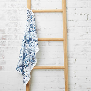 starla blue and white floral patterned kitchen towel hanging on ladder
