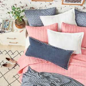 white and blue indigo striped bengal stripe throw blanket with tassel fringe styled on pink bedding