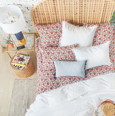 indigo brett decorative pillow styled on floral bedding