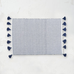 handwoven indigo and white striped placemat with tassels