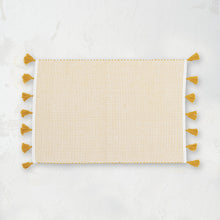 handwoven yellow ochre and white striped placemat with tassels