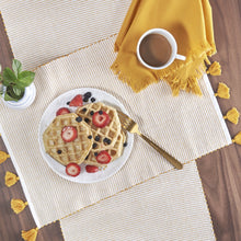 yellow ochre and white striped hand woven placemat with tassels