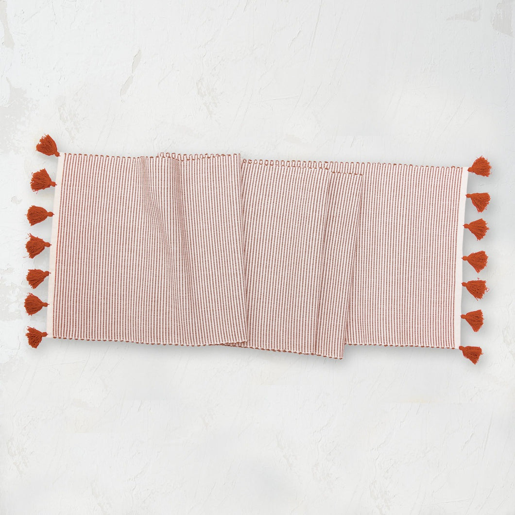 orange canyon and white striped handwoven placemat with tassels