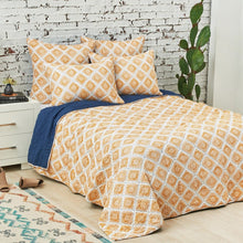 carver reversible quilt featuring a yellow and white pattern on one side and a solid indigo on the other side