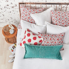 colley pillows styled on a white quilt