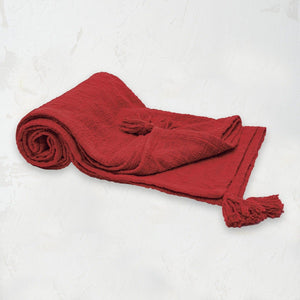 red woven devin throw blanket with tassel detail on the corners