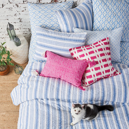 garrett blue and white striped bedding styled with a pink pop of color