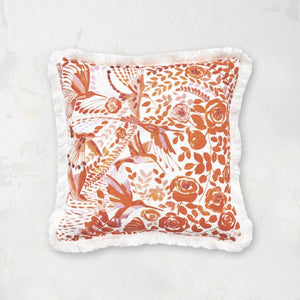 orange and white hummingbird floral design pillow with fringe