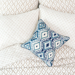 jax decorative throw pillow on a bed