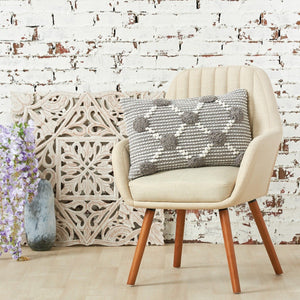 josie decorative throw pillow in beige styled on an armchair