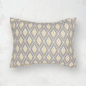 liam standard sham featuring a gray white and yellow geometric pattern
