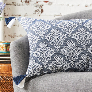 lottie floral decorative pillow in blue and white on a sofa