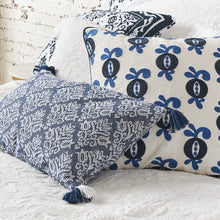 lottie floral decorative pillow in blu eand white on a bed