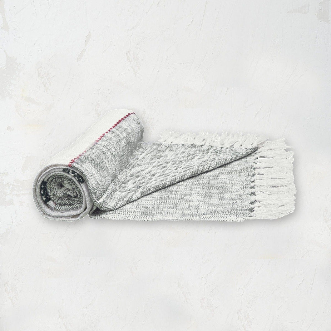 grey and white striped luna throw with red and black accents and tassel fringe