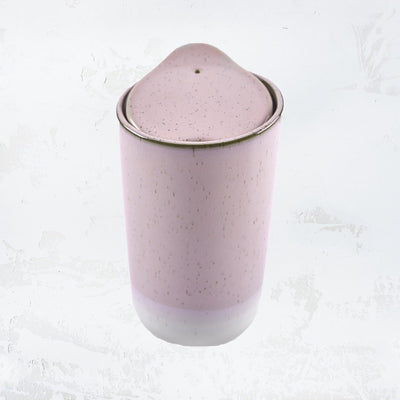 stoneware travel mug with a light pink speckled glaze