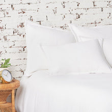 white monroe blanket and matching pillows on a bed