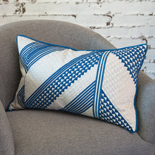geometric niles decorative throw pillow styled on an armchair