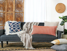 reggie geometric decorative throw pillow styled on a sofa