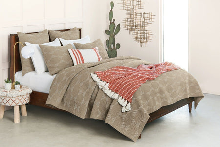 riley throw blanket in red styled on tan bedding