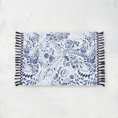 starla placemat with an indigo and white screen printed floral pattern and tassel fringe