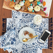 starla placemat with an indigo and white screen printed floral pattern and indigo tassel fringe
